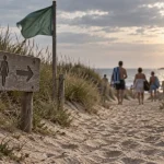 Entrée plages naturistes en Normandie, sentier sableux et panneaux bois